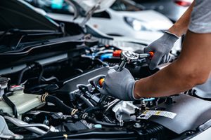 Mechanic,Using,Wrench,While,Working,On,Car,Engine,At,Garage - Meineke Seattle and Tacoma Meineke Car Care | Knock Sensor | Tacoma