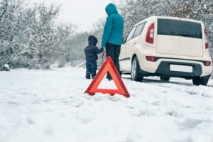 Woman,With,A,Child,On,The,Winter,Road.,Emergency,Sign - Meineke Seattle and Tacoma Meineke Car Care | Winter Maintenance | Lakewood